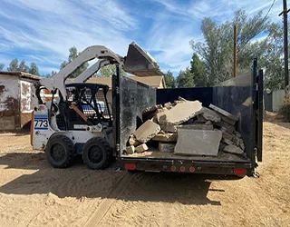 Excavator on rubble pile.