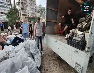 Loading bags of waste.