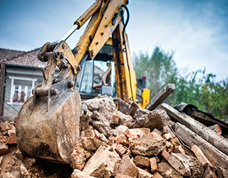 Excavator on rubble pile.