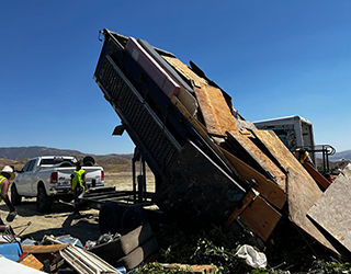 Dump trailer tipping debris.