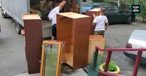 Furniture being loaded for disposal.