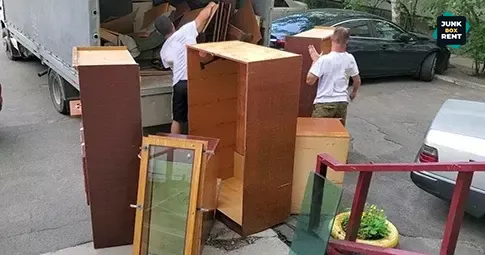 Furniture being loaded for disposal.